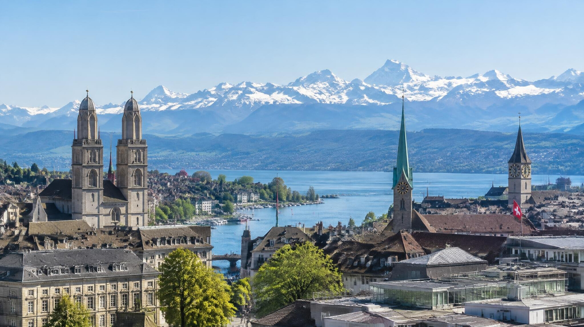 View of a Swiss city skyline with mountains in the background